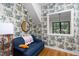 Living room featuring an accent wall with playful wallpaper and a comfortable blue couch at 1503 Hollywood St, Durham, NC 27701