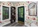 Mudroom featuring wallpaper, a wooden shoe rack, and a green exterior door at 1503 Hollywood St, Durham, NC 27701