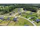 Aerial view of a neighborhood showcasing homes with large fenced backyards, green lawns, and mature trees at 171 Piney Field Rd, Fuquay Varina, NC 27526