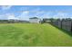 Large backyard with healthy green grass, wood fence, and play set at 171 Piney Field Rd, Fuquay Varina, NC 27526