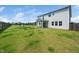 Spacious backyard featuring lush green grass, a wooden fence, and a vinyl sided house at 171 Piney Field Rd, Fuquay Varina, NC 27526