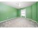 Bedroom with a bright green accent wall, neutral carpet and a ceiling fan at 171 Piney Field Rd, Fuquay Varina, NC 27526
