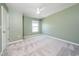 Bedroom with a light green accent wall, neutral carpet and a ceiling fan at 171 Piney Field Rd, Fuquay Varina, NC 27526