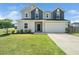 Traditional two story home with a two car garage, manicured lawn, and welcoming entrance at 171 Piney Field Rd, Fuquay Varina, NC 27526
