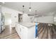 Kitchen island offers white cabinets, gray granite countertops, and stainless fixtures at 171 Piney Field Rd, Fuquay Varina, NC 27526