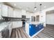 Bright kitchen boasts stainless appliances, white cabinets, and a granite island at 171 Piney Field Rd, Fuquay Varina, NC 27526