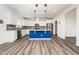 Kitchen features white cabinets, stainless steel appliances, gray backsplash, and a blue island at 171 Piney Field Rd, Fuquay Varina, NC 27526