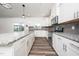 The updated kitchen features a gray backsplash, stainless appliances, and an island with a granite countertop at 171 Piney Field Rd, Fuquay Varina, NC 27526