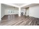 Living room showcasing a staircase, wood flooring, and an open-concept design to the kitchen at 171 Piney Field Rd, Fuquay Varina, NC 27526
