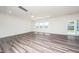 Spacious open-concept living room offers a ceiling fan, recessed lights, and sliding door to the yard at 171 Piney Field Rd, Fuquay Varina, NC 27526