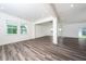 Bright living room features gray wood floors, recessed lighting, and neutral paint at 171 Piney Field Rd, Fuquay Varina, NC 27526