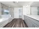 Bright bathroom features a double vanity and glass enclosed shower next to a soaking tub at 171 Piney Field Rd, Fuquay Varina, NC 27526