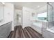 Bright bathroom features a double vanity and glass enclosed shower next to a soaking tub at 171 Piney Field Rd, Fuquay Varina, NC 27526