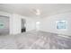 Large bedroom with bright white walls, neutral carpet, ceiling fan and a view of the neighborhood at 171 Piney Field Rd, Fuquay Varina, NC 27526
