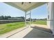 Covered screened porch overlooking backyard with concrete flooring and ceiling fan at 171 Piney Field Rd, Fuquay Varina, NC 27526