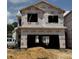 New two-story house under construction with visible framing and a two-car garage at 184 W Allen St, Four Oaks, NC 27524