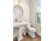 Bright half-bath features a pedestal sink and natural light coming in from the window at 192 Glenpark Pl, Cary, NC 27511