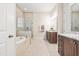 Luxurious bathroom with tiled shower, large tub, granite countertops and wood cabinets at 192 Glenpark Pl, Cary, NC 27511