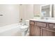 Clean bathroom showcasing a tiled bathtub with a showerhead, toilet, and a stylish vanity at 192 Glenpark Pl, Cary, NC 27511