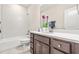 Elegant bathroom showcasing a stylish vanity, subway tile backsplash, and combined tub-shower at 192 Glenpark Pl, Cary, NC 27511