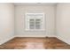 Simple room showcasing a hardwood floor, neutral paint and a bright window at 192 Glenpark Pl, Cary, NC 27511