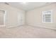 Bright bedroom featuring neutral walls, plush carpeting, closet, and a window with natural light at 192 Glenpark Pl, Cary, NC 27511