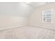 Bonus room with neutral carpet, an attic window and sloped ceiling at 192 Glenpark Pl, Cary, NC 27511