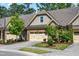 Attractive townhome featuring brick, stone, and shingle exterior with a well-maintained lawn and two-car garage at 192 Glenpark Pl, Cary, NC 27511