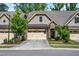 Charming townhome with stone and brick accents, well-manicured landscaping, and attached two-car garage at 192 Glenpark Pl, Cary, NC 27511