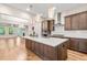 Spacious kitchen with a large island, stylish pendant lights, stainless steel appliances, and hardwood flooring at 192 Glenpark Pl, Cary, NC 27511