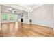 Bright living room featuring hardwood floors, built-in bookshelves, a fireplace, and large windows at 192 Glenpark Pl, Cary, NC 27511