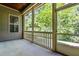 Enclosed screened in porch with concrete floors, an additional window, and wooded views at 192 Glenpark Pl, Cary, NC 27511