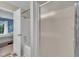 A bathroom featuring a shower/tub with a white shower curtain, adjacent to the bedroom through an open door at 201 Crossfire Rd, Holly Springs, NC 27540