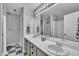Spacious bathroom featuring dual sinks, a large mirror, and ample counter space at 201 Crossfire Rd, Holly Springs, NC 27540