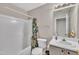 Clean bathroom with a tub, shower, and white vanity with great lighting at 201 Crossfire Rd, Holly Springs, NC 27540