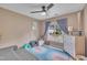 Cozy bedroom featuring a ceiling fan, neutral walls, and a colorful rug at 201 Crossfire Rd, Holly Springs, NC 27540
