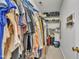 View of a walk-in closet with clothes hanging from the rod and organized on the shelves at 201 Crossfire Rd, Holly Springs, NC 27540
