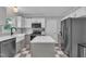 The kitchen has a center island, stainless appliances, and stone countertops at 201 Crossfire Rd, Holly Springs, NC 27540