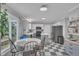 Eat-in kitchen features modern appliances, breakfast area, and black and white tile flooring at 201 Crossfire Rd, Holly Springs, NC 27540