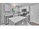 Updated kitchen with white cabinets, stainless steel appliances, and a center island at 201 Crossfire Rd, Holly Springs, NC 27540