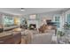 Comfortable living room with fireplace, piano, neutral tones, and ample natural light at 201 Crossfire Rd, Holly Springs, NC 27540