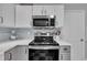 Updated stainless steel stove and microwave with tile backsplash and quartz countertops at 201 Crossfire Rd, Holly Springs, NC 27540