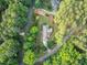 Aerial view showcasing a house surrounded by a dense, green forest landscape at 201 Village Dr, Knightdale, NC 27545