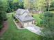 Aerial view of a stunning home with a spacious driveway, lush lawn, mature trees, and meticulously maintained landscaping at 201 Village Dr, Knightdale, NC 27545