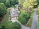 Aerial view of a home with long driveway, manicured lawn, mature trees and rear deck at 201 Village Dr, Knightdale, NC 27545
