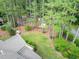 Aerial view showcasing a lush backyard with mature trees and a well-maintained lawn at 201 Village Dr, Knightdale, NC 27545