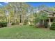 Green backyard featuring mature trees and professionally landscaped greenery at 201 Village Dr, Knightdale, NC 27545