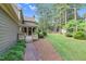 Spacious backyard with a brick path leading to a shed, lush lawn, and ample privacy at 201 Village Dr, Knightdale, NC 27545