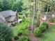 Expansive backyard with a deck, mature trees, lush greenery, and additional outbuilding, perfect for outdoor enjoyment at 201 Village Dr, Knightdale, NC 27545