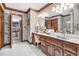 Elegant bathroom featuring a wood vanity, decorative wallpaper, and tile flooring at 201 Village Dr, Knightdale, NC 27545